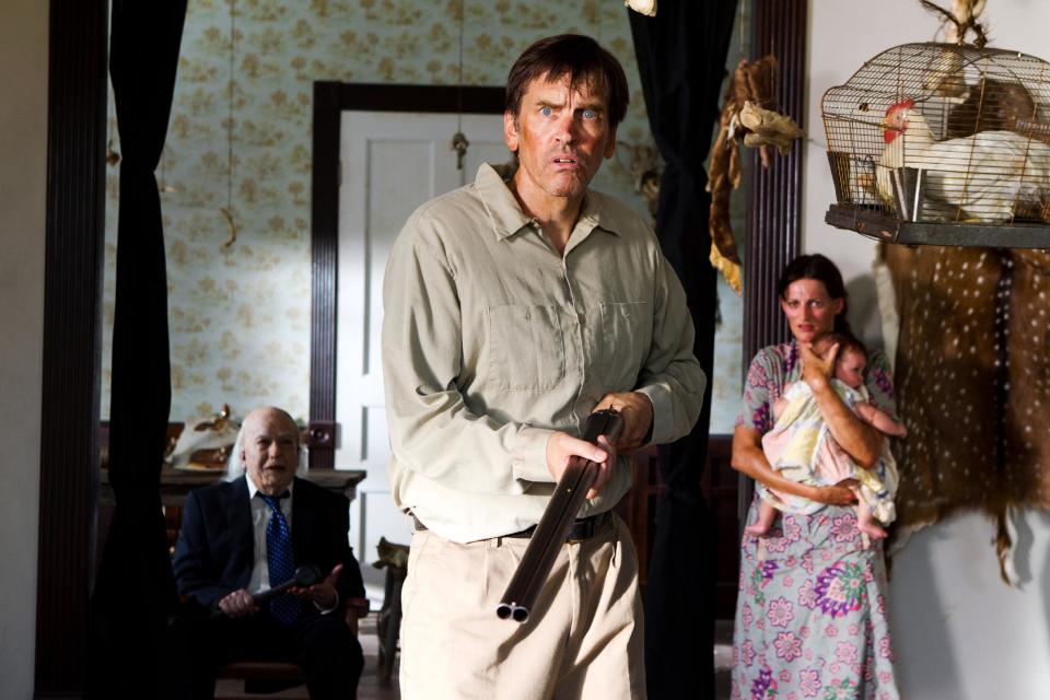 This undated publicity film image from Lionsgate shows John Dugan, left, as Grandpa Sawyer, and Bill Moseley, center, as Drayton Sawyer, in a scene from "Texas Chainsaw 3-D," releasing in theaters on Friday, January 4, 2013. (AP Photo/Lionsgate, Justin Lubin)