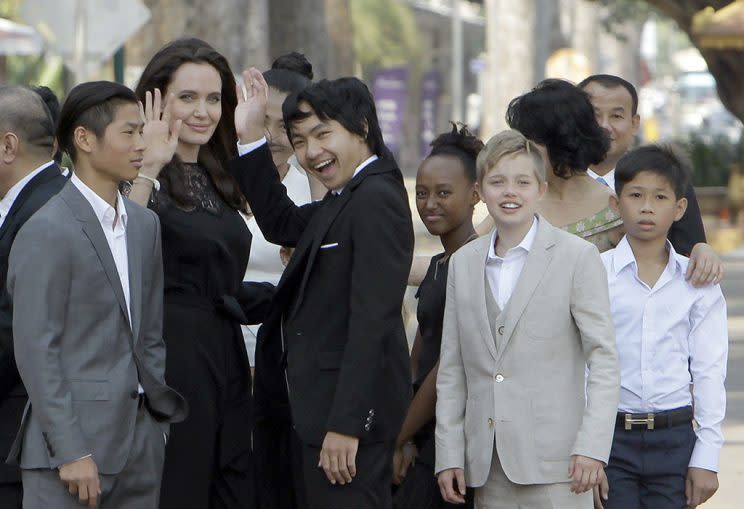 Angelina Jolie, second from left, waves with her adopted children Pax, left, Maddox, center, Zahara, third from right, and Shiloh