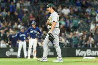 Oakland Athletics relief pitcher Trevor May apologizes to Seattle Mariners' Eugenio Suarez after hitting him with a pitch during the eighth inning of a baseball game Tuesday, May 23, 2023, in Seattle. (AP Photo/Caean Couto)