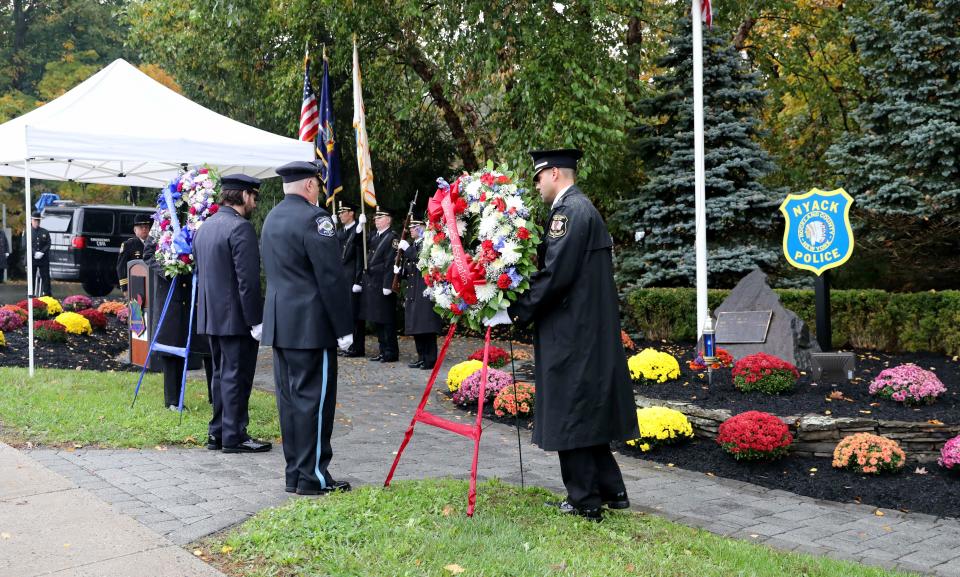 Memorial wreaths from the Police Chief's Association of Rockland County and the Rockland County P.B.A. are placed during the 42nd annual Brinks robbery memorial service for slain Nyack Police Sergeant Edward O'Grady, Police Officer Waverly L. Brown and Brinks guard Peter Paige, during the ceremony on Mountainview Avenue in Nyack, Oct. 20, 2023.