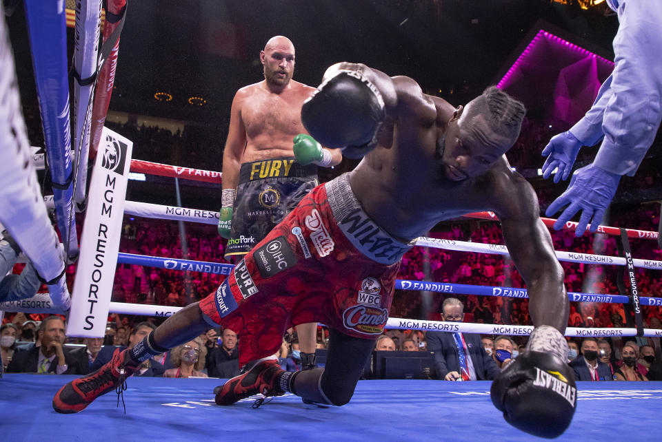 Pictured here, Deontay Wilder (R) crashes to the canvas during his trilogy fight defeat to Tyson Fury.