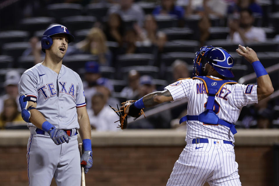 Texas Rangers' Nathaniel Lowe reacts after striking out as New York Mets catcher Omar Narvaez throws the ball during the ninth inning of a baseball game Wednesday, Aug. 30, 2023, in New York. (AP Photo/Adam Hunger)