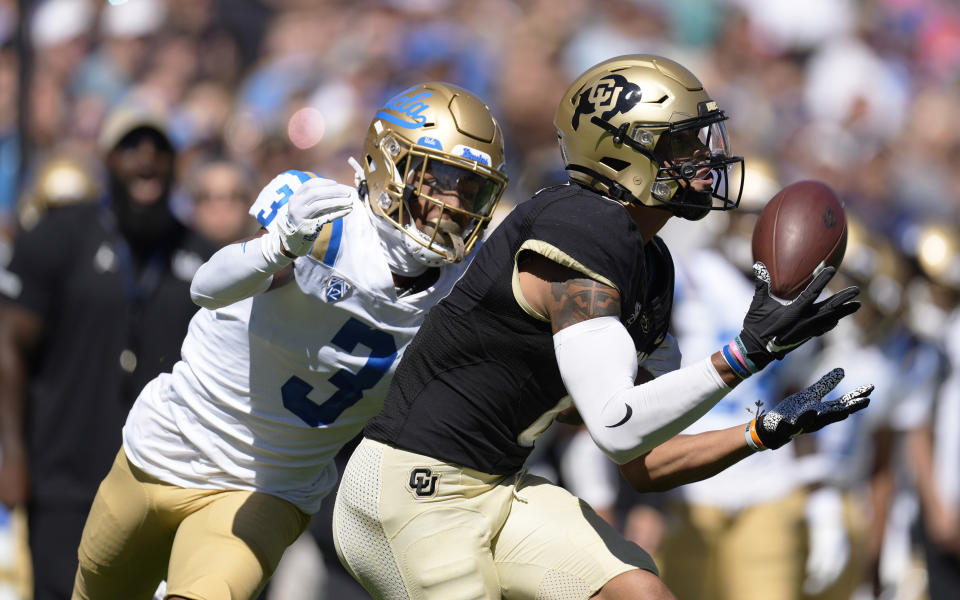 Colorado wide receiver Daniel Arias, front, pulls in a pass in front of UCLA defensive back Devin Kirkwood in the first half of an NCAA college football game Saturday, Sept. 24, 2022, in Boulder, Colo. (AP Photo/David Zalubowski)