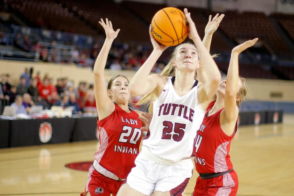 Tuttle's Landry Allen puts up a shot from between Stilwell's Jayli Christie, left, and Shannon Catron on March 8.