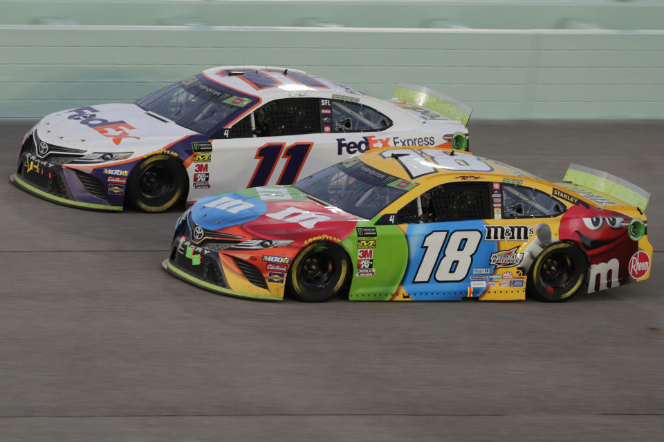 Kyle Busch (18) and Denny Hamlin (11) are seen during the NASCAR Cup Series auto racing season championship race at Homestead-Miami Speedway in Homestead, Fla., Sunday, Nov. 17, 2019. Busch won the NASCAR Cup Series auto racing season championship.(AP Photo/Luis M. Alvarez)