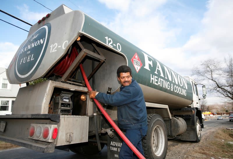 FILE PHOTO: Chip Johnson fills a residential oil tank in Alexandria, Virginia