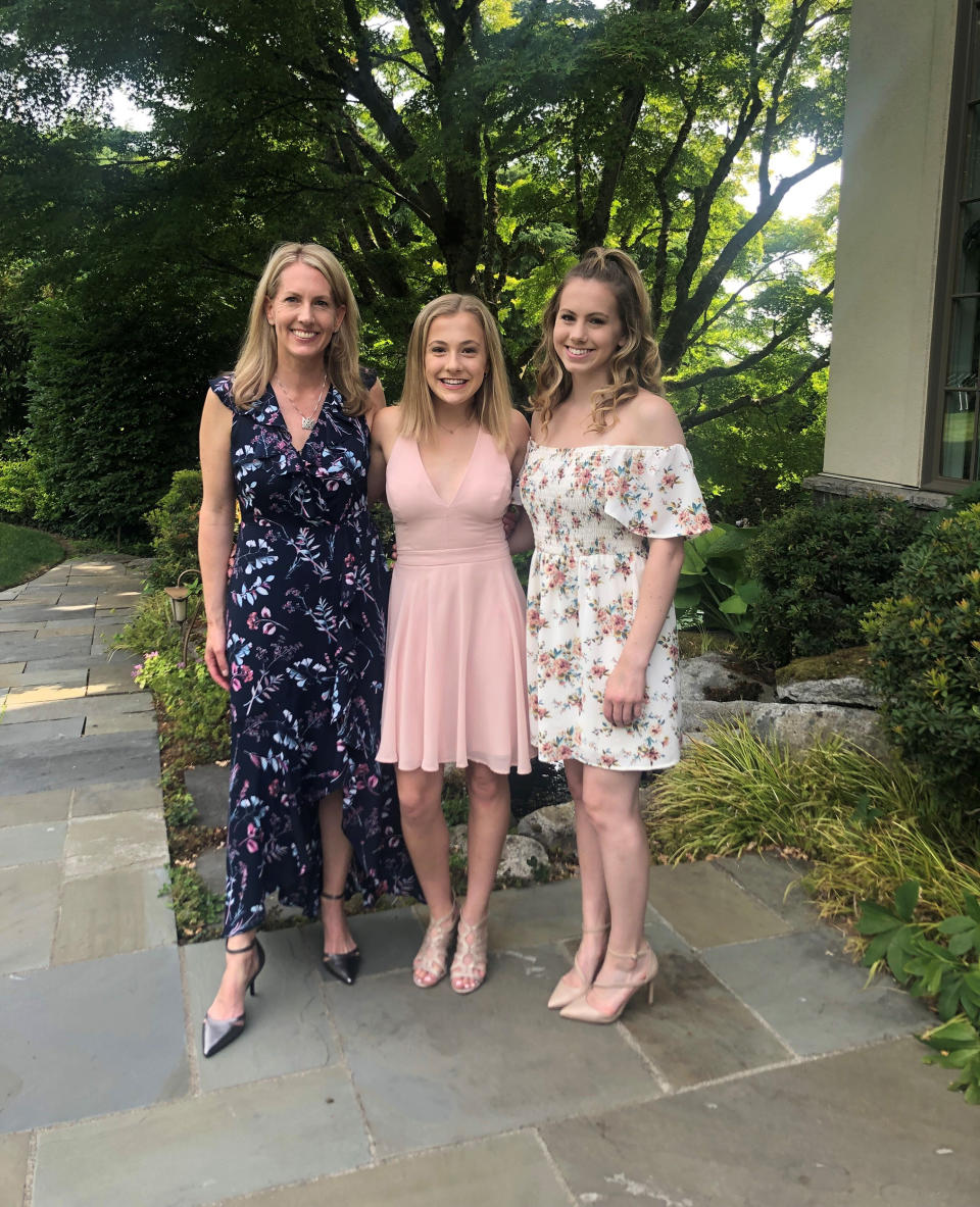 Mezulis with daughters Anna and Elsie at Elsie's 8th grade graduation. (courtesy Amy Mezulis)