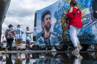 Fans walk by an image of Inter Miami's Lionel Messi as they arrive to attend an MLS soccer match against the New York Red Bulls at Red Bull Arena, Saturday, Aug. 26, 2023, in Harrison, N.J. (AP Photo/Eduardo Munoz Alvarez)