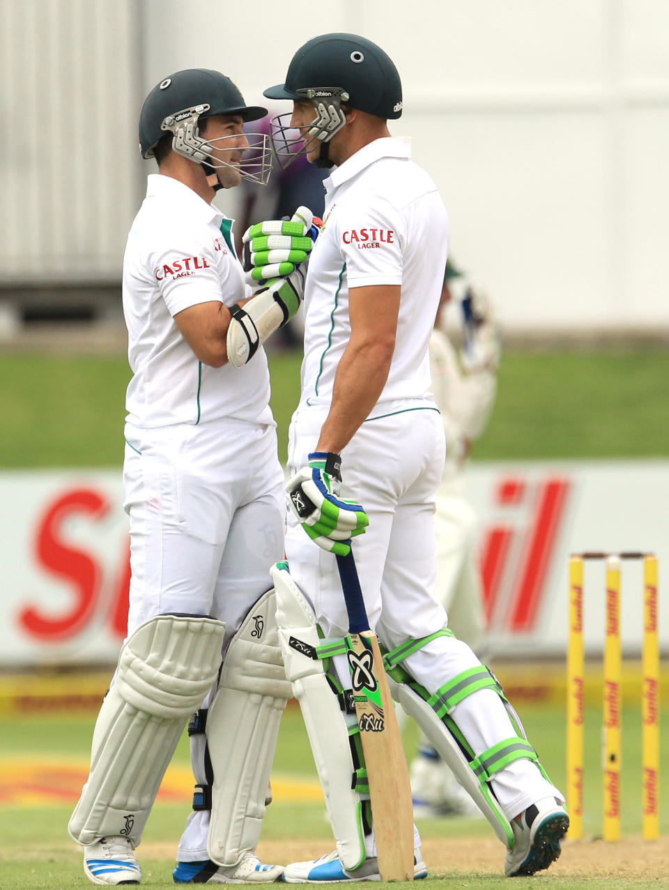 South Africa's batsman Dean Elgar, left, shakes hand with teammate Faf du Plessis, right, after reaching his half century on the first day of their 2nd cricket test match at St George's Park in Port Elizabeth, South Africa, Thursday, Feb. 20, 2014. (AP Photo/ Themba Hadebe)