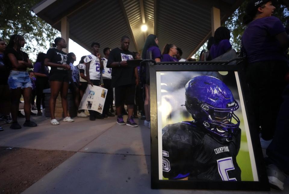 Family and friends hold a vigil for Christopher Hampton, a 15-year-old Cesar Chavez High School football player who was found dead in Show Low Lake.