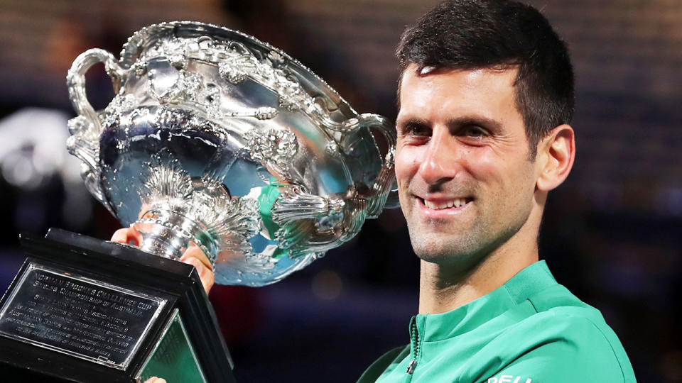 Pictured here, Novak Djokovic holds the 2021 Australian Open trophy aloft.