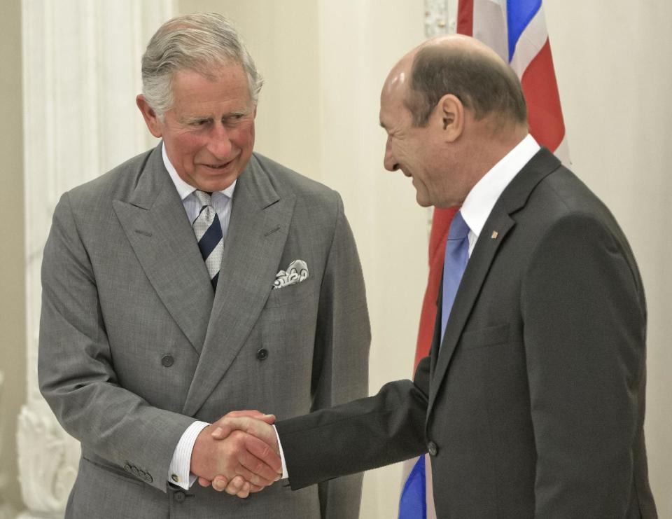 Britain's Prince Charles, left, shakes hands with Romania's President Traian Basescu, right, at the Cotroceni Presidential Palace in Bucharest, Romania. Monday, June 3, 2013.(AP Photo/Vadim Ghirda)