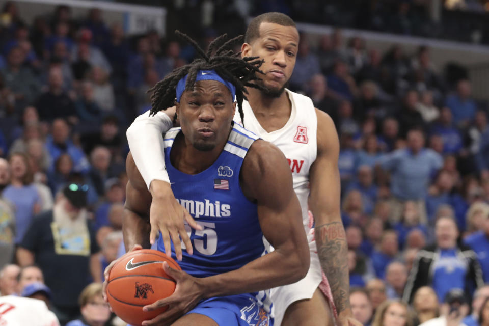 Memphis forward Precious Achiuwa (55) goes up for a basket as Houston forward Justin Gorham (4) defends in the second half of an NCAA college basketball game Saturday, Feb. 22, 2020, in Memphis, Tenn. (AP Photo/Karen Pulfer Focht)