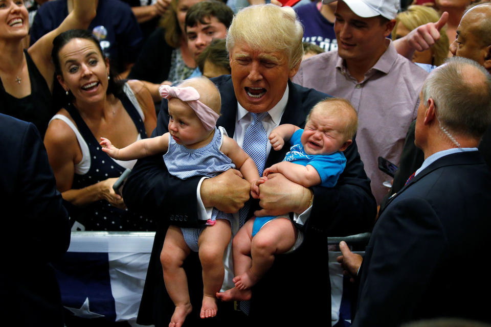 Trump holds a pair of babies