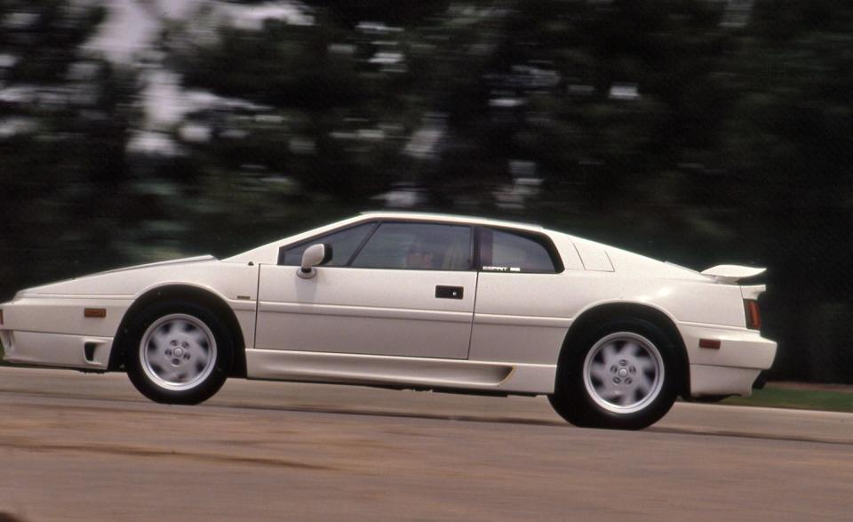 <p><em>December 1989</em></p><p>What We Said: “The Lotus Esprit Turbo SE produces 264 hp at 6500 rpm-a 36-hp increase over the standard-issue 1990 Esprit Turbo. Of course, the SE package adds twelve grand to the sticker, which works out to $333 per bonus horsepower. But that’s okay. The outlay of extra cash gives you bragging rights to an engine producing 120 hp per liter-the highest specific-output piston engine available to American speed addicts. All that from a sixteen-valve 2.2-liter four that, in its minuscule mid-engine cubbyhole, looks about the size of the power-steering pump on a Ford LTD. . . . Drop the clutch at 5300 rpm and prepare to have your nose assume the proportions of a ten-pence coin. Sixty miles per hour is yours in 4.8 seconds, a half-second improvement over the non-charge-cooled Esprit we tested earlier. That’s also quicker than a Lamborghini Countach or a Ferrari Testarossa, never mind such moon-calf machinery as the Ferrari 328GTS. (Forgive us; you tend to feel smug in a car like this. At stoplights, you look straight ahead and ignore motorists gesticulating for your attention. Do these people expect us to waste fuel and burn rubber in a vulgar display of power? Okay, maybe just one more time.) . . . It isn’t until the turbo spools up at 3000 rpm that the Lotus feels as if it had just been fired out of the sixteen-inch cannon atop the USS <em>Iowa</em>. Unless you’re willing to perform Garlits-quality burnouts, do not enter into impromptu drag races that last only 100 feet or so, or your nephew’s jacked-up Z28 will put the Esprit SE on the trailer. Little of which matters, of course, on twisty two-lane country roads, as the Lotus snakes and slinks through corners like a ferret in a vineyard.”</p>