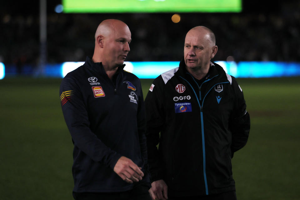 ADELAIDE, AUSTRALIA - AUG 17: Matthew Nicks, Senior Coach of the Crows talks to Ken Hinkley, Senior Coach of the Power during the 2024 AFL Round 23 match between the port Adelaide Power and the Adelaide Crows at Adelaide Oval on August 17, 2024 in Adelaide, Australia. (Photo by James Elsby/AFL Photos via Getty Images)