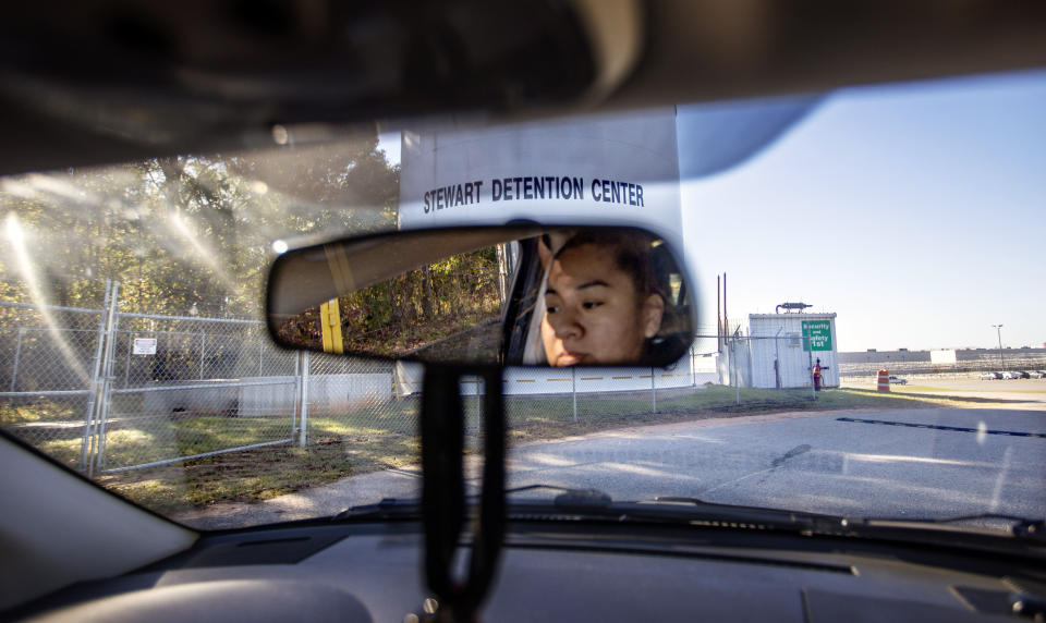 Lucia approaches the Stewart Detention Center to visit her brother-in-law, Sunday, Nov. 10, 2019, in Lumpkin, Ga. Lucia's husband was deported a year ago from the same ICE facility where her brother-in-law is now detained. "You think the second time would get easier," said Lucia. "But it doesn't get easier. It's the same emotions, the same anxiousness of what could happen." (AP Photo/David Goldman)