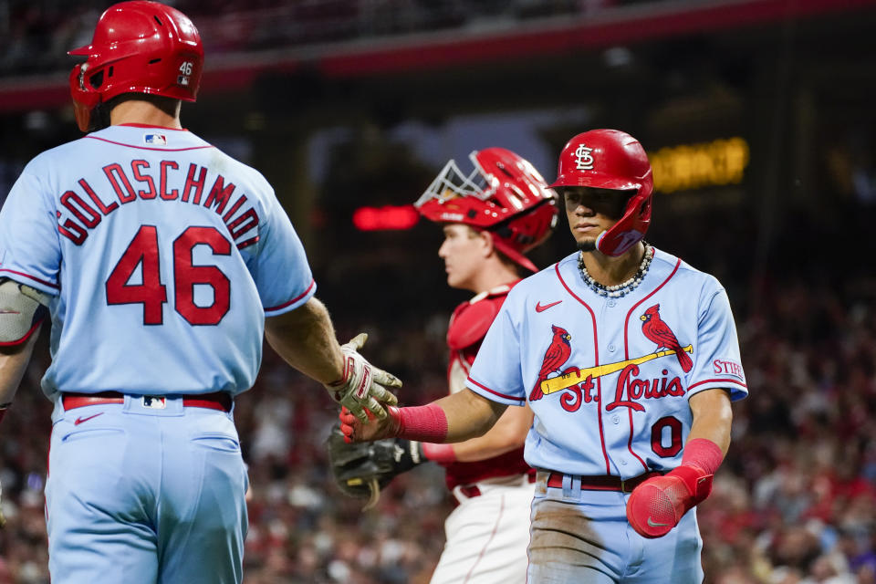 St. Louis Cardinals' Masyn Winn, right, celebrates with teammate Paul Goldschmidt after scoring on an RBI double by Lars Nootbaar during the fourth inning of a baseball game, Saturday, Sept. 9, 2023, in Cincinnati. (AP Photo/Joshua A. Bickel)