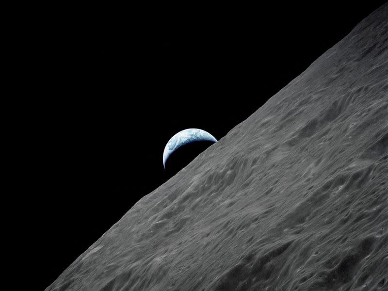 FILE PHOTO: The crescent Earth rises above the lunar horizon in this NASA handout photograph taken from the Apollo 17 spacecraft in lunar orbit