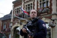 <p>A policeman secures a position in front of the city hall after two assailants had taken five people hostage in the church at Saint-Etienne-du -Rouvray near Rouen in Normandy, France, July 26, 2016. (REUTERS/Pascal Rossignol)</p>