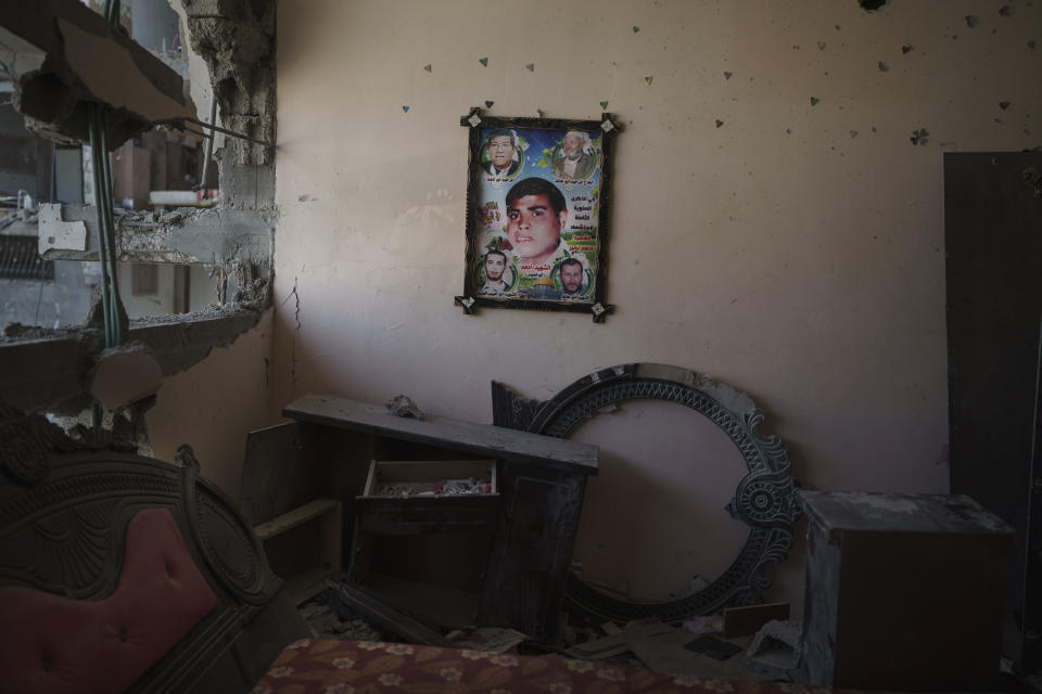 A poster with a photo of Adham Nassir, a cart driver who died in the 2008 war, hangs on the wall of his widow's house, which was heavily damaged by airstrikes in the recent 11-day war in Beit Hanoun, northern Gaza Strip, Sunday, June 13, 2021. (AP Photo/Felipe Dana)