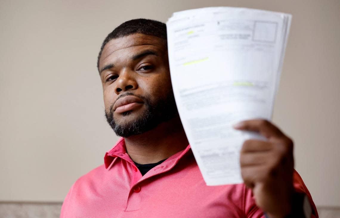 Kevin Spruill holds up his release paperwork that he keeps with him in case he is stopped and detained by authorities on a arrest warrant that should have been recalled. Spruill is one of several plaintiffs who signed onto a potential class action lawsuit filed in federal courts alleging that the rollout of the state’s eCourt system violated their civil rights. Photographed August 24, 2023.