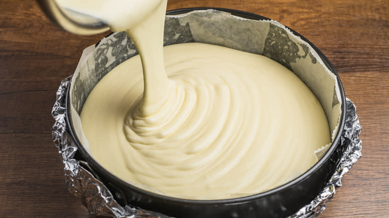 cheesecake batter pouring into pan