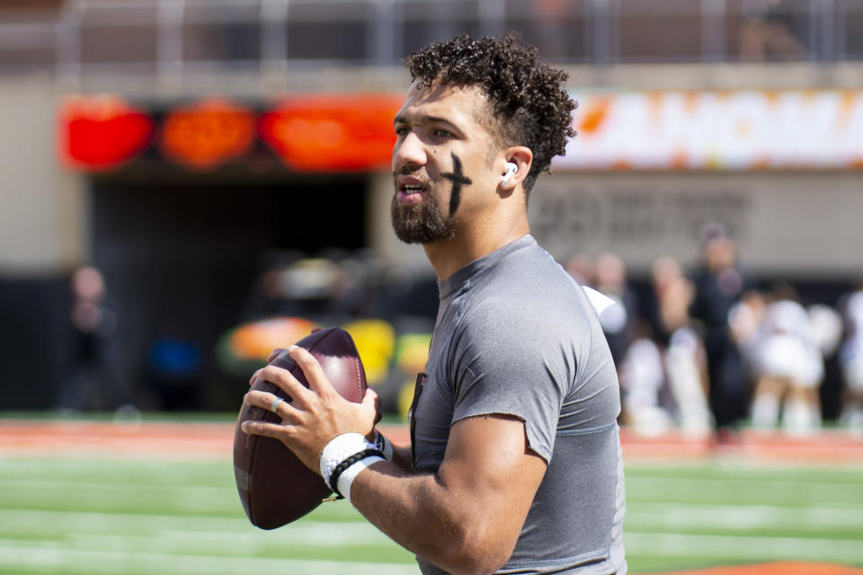 FILE - Then-Oklahoma State quarterback Spencer Sanders (3) warms up before an NCAA college football game against Texas Tech in Stillwater, Okla., Saturday Oct. 8, 2022. Sanders now plays for Ole Miss. Ole Miss opens their season at home against Mercer on Sept. 2. (AP Photo/Mitch Alcala, File)