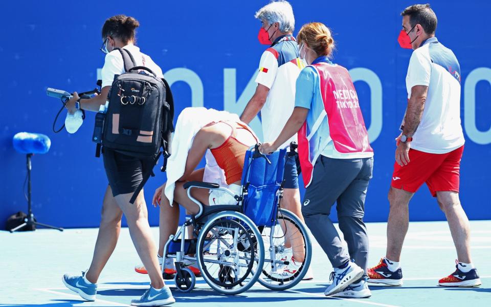 Paula Badosa leaves the court in a wheelchair - REUTERS