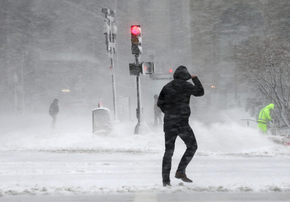 A pedestrian made his way across Congress St. in downtown Boston during a powerful snow storm. Lloyd Young/Getty Images