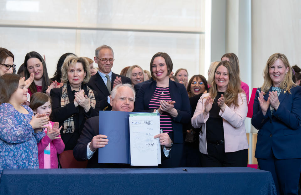 Gov. Tim Walz, center