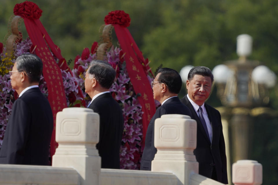 Chinese President Xi Jinping, right, walks near the Monument to the People's Heroes during a ceremony to mark Martyr's Day at Tiananmen Square in Beijing on Wednesday, Sept. 30, 2020. (AP Photo/Ng Han Guan)