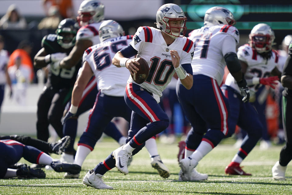 New England Patriots quarterback Mac Jones (10) carries the ball against the New York Jets during the first quarter of an NFL football game, Sunday, Oct. 30, 2022, in New York. (AP Photo/John Minchillo)