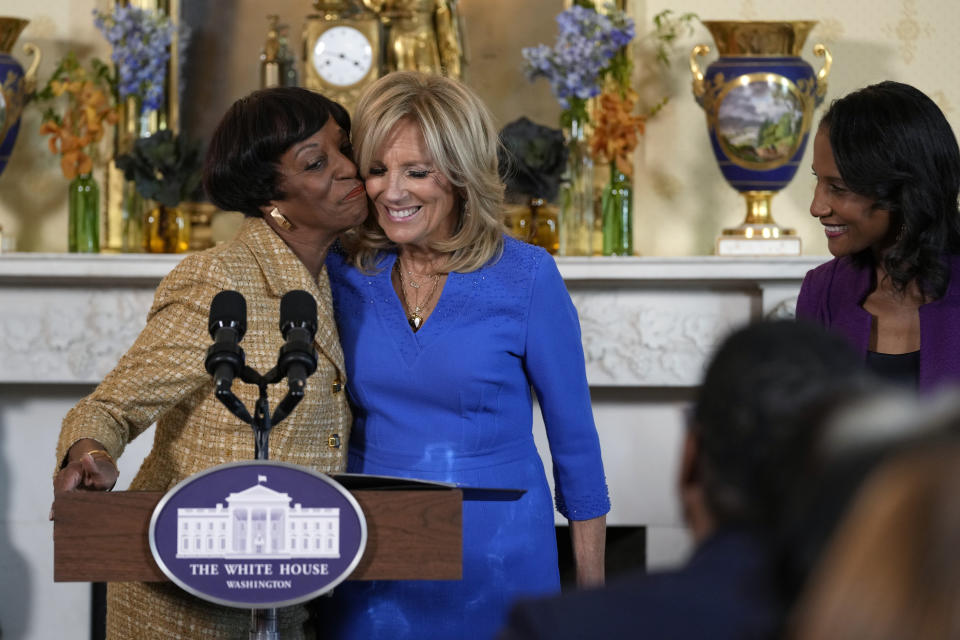 First lady Jill Biden, center, gets a hug and a kiss from Robin Jackson, left, wife of Charles Jackson, pastor of Brookland Baptist Church in West Columbia, S.C., as Candace Shiver watches at right, during a celebration of the Thanksgiving season with African American women faith leaders, community leaders and advocates from the Southeast, in the Blue Room of the White House in Washington, Monday, Nov. 13, 2023. (AP Photo/Susan Walsh)