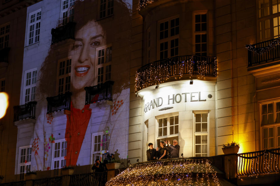 Family of Nobel Peace Prize winner Narges Mohammadi, husband Taghi Rahmani and their children Ali and Kiana Rahmani, center, watch a torchlight procession in honor of the Nobel Peace Prize laureate in Oslo, Norway, Sunday Dec. 10, 2023. Narges Mohammadi was awarded the 2023 Nobel Peace Prize in October for her decades of activism despite numerous arrests by Iranian authorities and spending years behind bars. She is renowned for campaigning for women's rights and democracy in her country, as well as fighting against the death penalty. (Hanna Johre/NTB via AP)