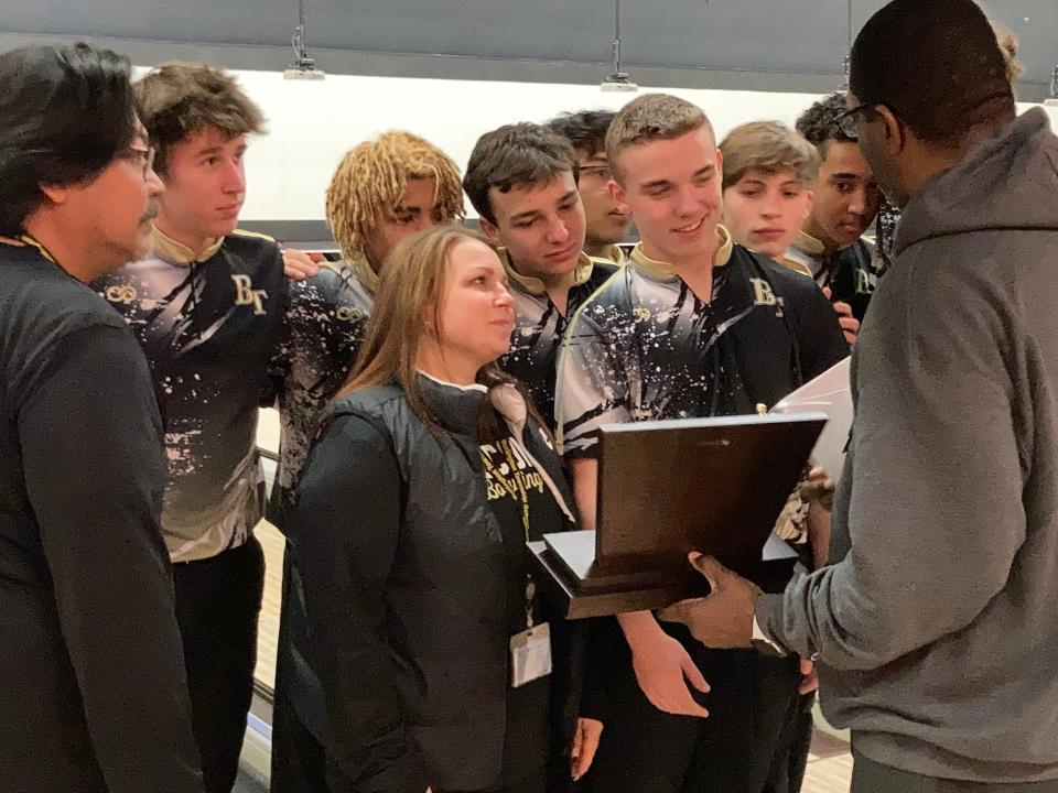 Burlington Township  coach Tiffany Rhea and her team accept the trophy from NJSIAA Director of Bowling Derryk Sellers after winning Group 2 at the state boys bowling team finals on Monday, Feb. 20, 2023 at Bowlero North Brunswick.