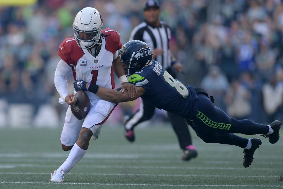 Seattle cornerback Coby Bryant strips the ball from Arizona quarterback Kyler Murray in the Seahawks' victory last Sunday. CAEAN COUTO/The Associated Press