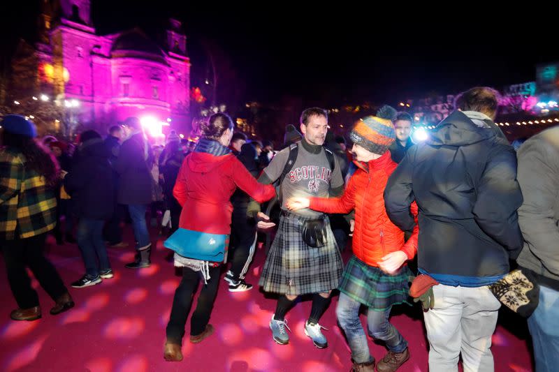 Revellers dance in the streets as they bring in the New Year at Edinburgh's Hogmanay celebrations, Edinburgh, Scotland