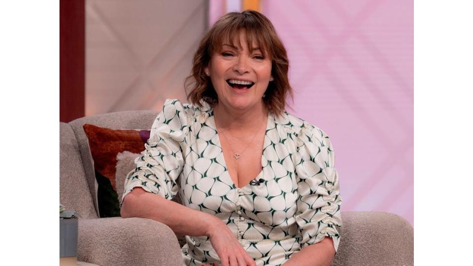 Lorraine Kelly laughing in a white dress