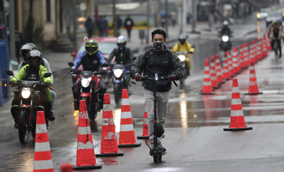 A man riding an electric scooter in a bike lane in Bogot&aacute;, Colombia, on March 16, 2020. Officials in the city have expanded bike routes, encouraging people to abandon crowded public transportation to lower the risk of catching the coronavirus. (Photo: AP Photo/Fernando Vergara)