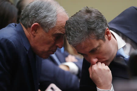 Michael Cohen, the former personal attorney of U.S. President Donald Trump, confers with his attorney and advisor Lanny Davis (L) as he testifies before a House Committee on Oversight and Reform hearing on Capitol Hill in Washington, U.S., February 27, 2019. REUTERS/Jonathan Ernst