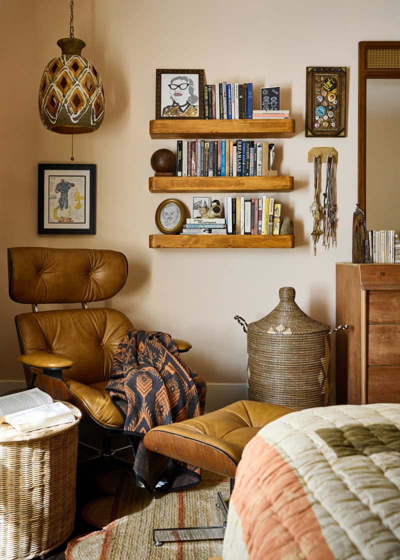 Bookshelves in eclectic bedroom.