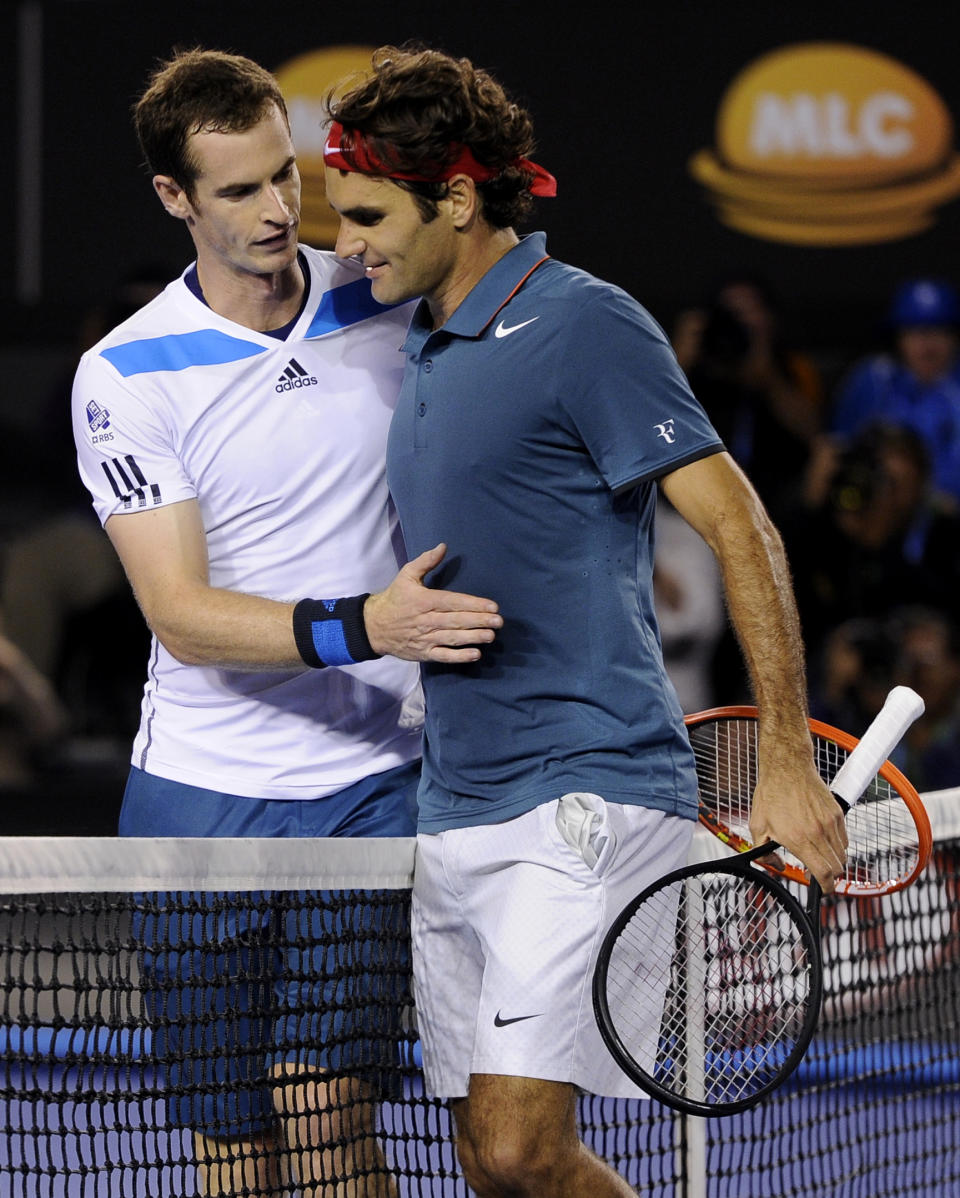 Roger Federer of Switzerland, right, is congratulated by Andy Murray of Britain at the net after Federer won their quarterfinal at the Australian Open tennis championship in Melbourne, Australia, Wednesday, Jan. 22, 2014.(AP Photo/Andrew Brownbill)