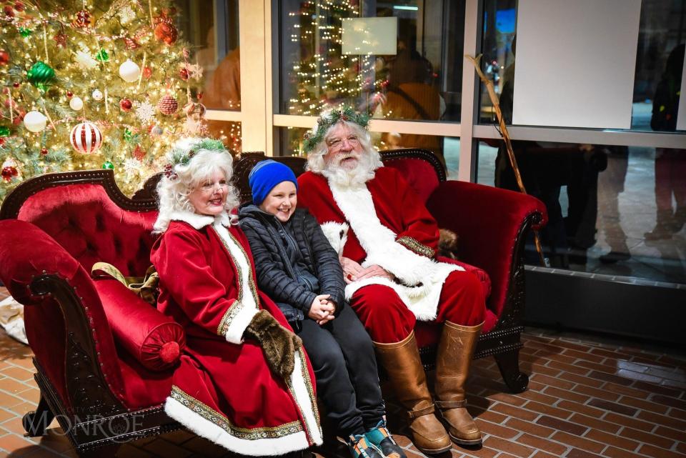 An area child visits Santa and Mrs. Claus at last year's Hometown Holiday Lights event in downtown Monroe. Santa will return this year.