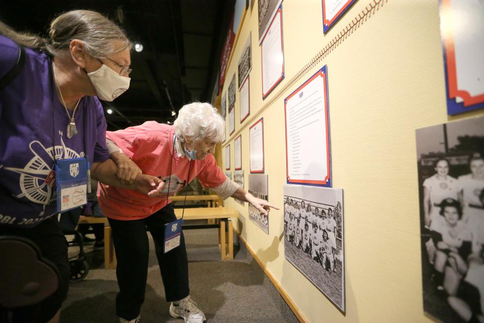 Sister Toni Palmero points out a photograph of her teammates to Kathleen Carter Friday, Aug. 19, 2022, in an exhibit of the All-American Girls Professional Baseball League at The History Museum.  Players, fans and families were in South Bend this past weekend for a reunion of the league in South Bend.