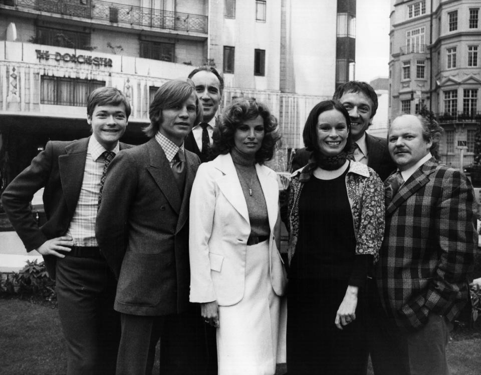 25th March 1974:  Stars of  the film 'The Three Musketeers' outside the Dorchester Hotel in London, where they gathered for a pre-release reception. They are, from left to right; Simon Ward, Michael York, Christopher Lee, Raquel Welch, Geraldine Chaplin, Jean Pierre Cassel and Roy Kinnear.  (Photo by Frank Barratt/Keystone/Getty Images)