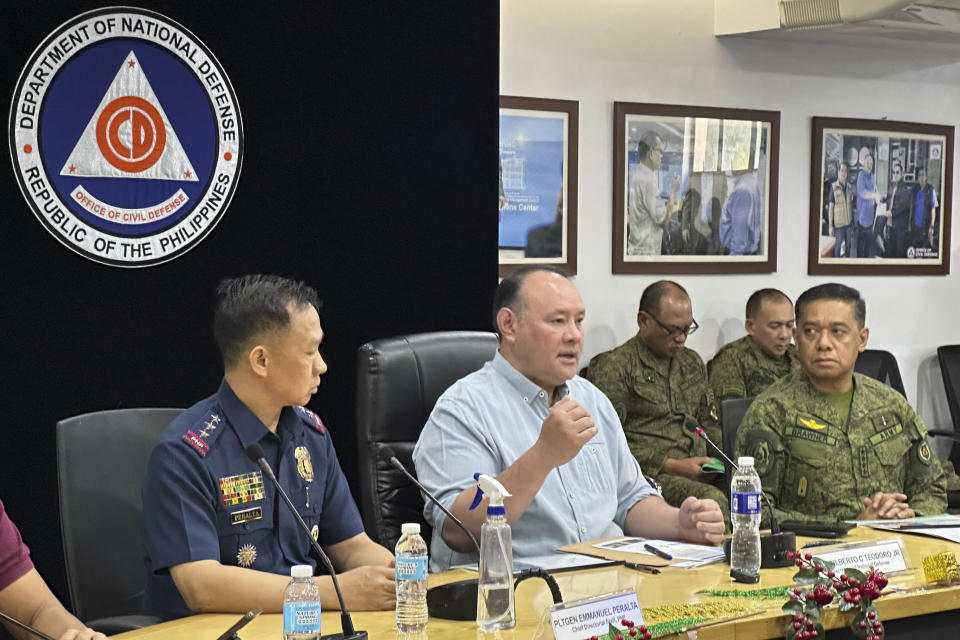 Philippine Defense Secretary Gilbert Teodoro, center, talks beside Philippine Military Chief Gen. Romeo Brawner Jr., right, as they hold a press conference in Quezon city, Philippines on Sunday Dec. 3, 2023. A powerful explosion believed caused by a bomb ripped through a Catholic Mass and killed several people and wounded dozens of others Sunday in a predominantly Muslim city in the southern Philippines, officials said. (AP Photo/Joeal Calupitan)