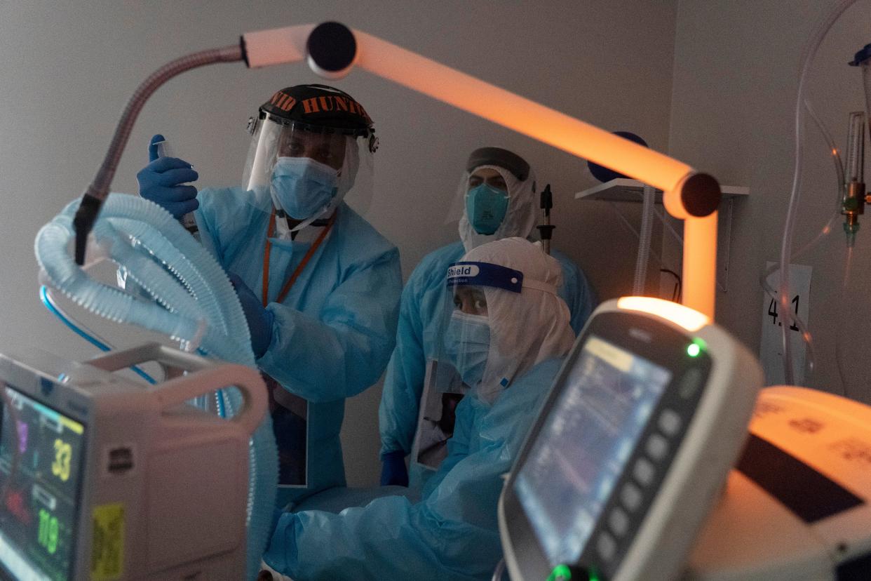 Medical staff members perform an endoscopy on a patient suffering from coronavirus in the COVID-19 intensive care unit (ICU) at United Memorial Medical Center on November 16, 2020 in Houston, Texas. Texas has recorded more than 1.1 million cases of the disease, with more than 20,000 deaths.  (Go Nakamura/Getty Images)