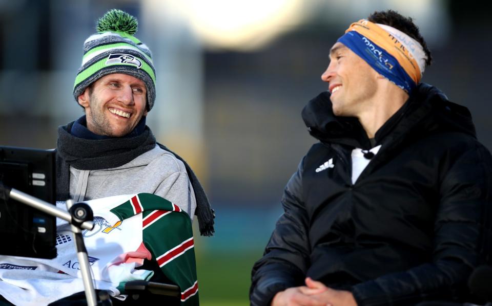 Ex-Leeds Rhinos rugby league player Kevin Sinfield (R) speaks with former teammate Rob Burrow after completing his Extra Mile Challenge at Emerald Headingley Stadium on November 23, 2021 in Leeds, England. - George Wood/Getty Images