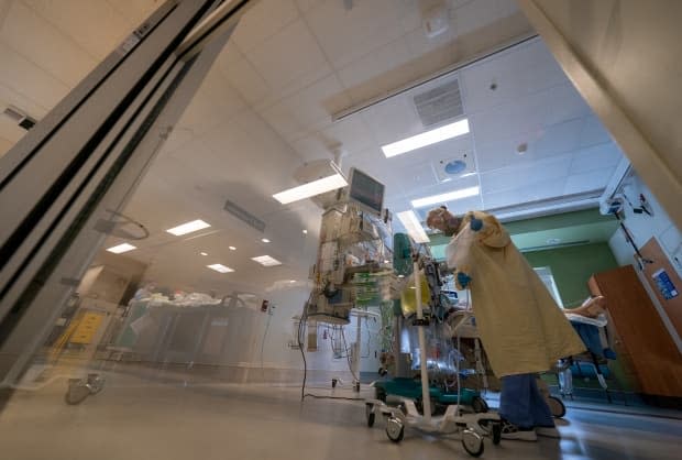 Nurse Linda Wright attends to a patient in the COVID-19 Intensive Care Unit at Surrey Memorial Hospital on June 4.  ( The Canadian Press/Jonathan Hayward - image credit)